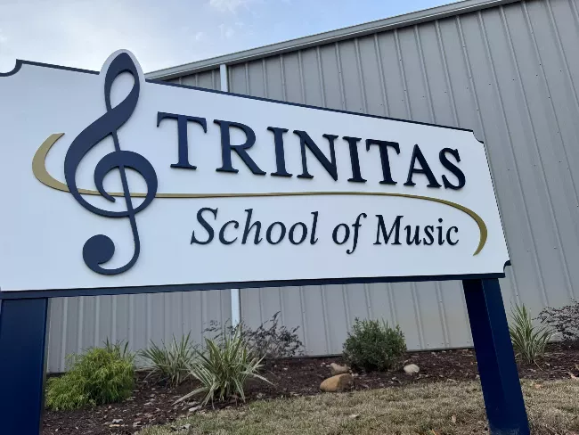Trinitas School of Music sign with treble clef.