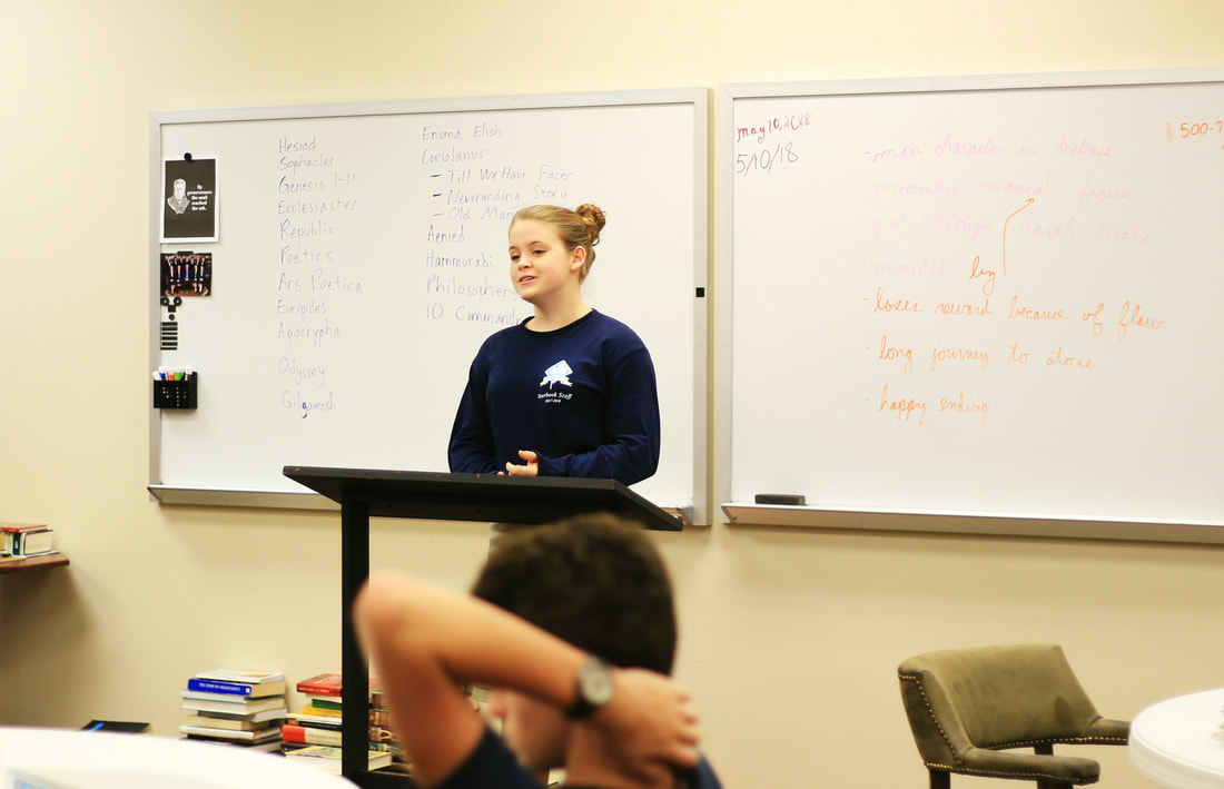 Rhetoric school student presenting in the classroom at Trinitas.