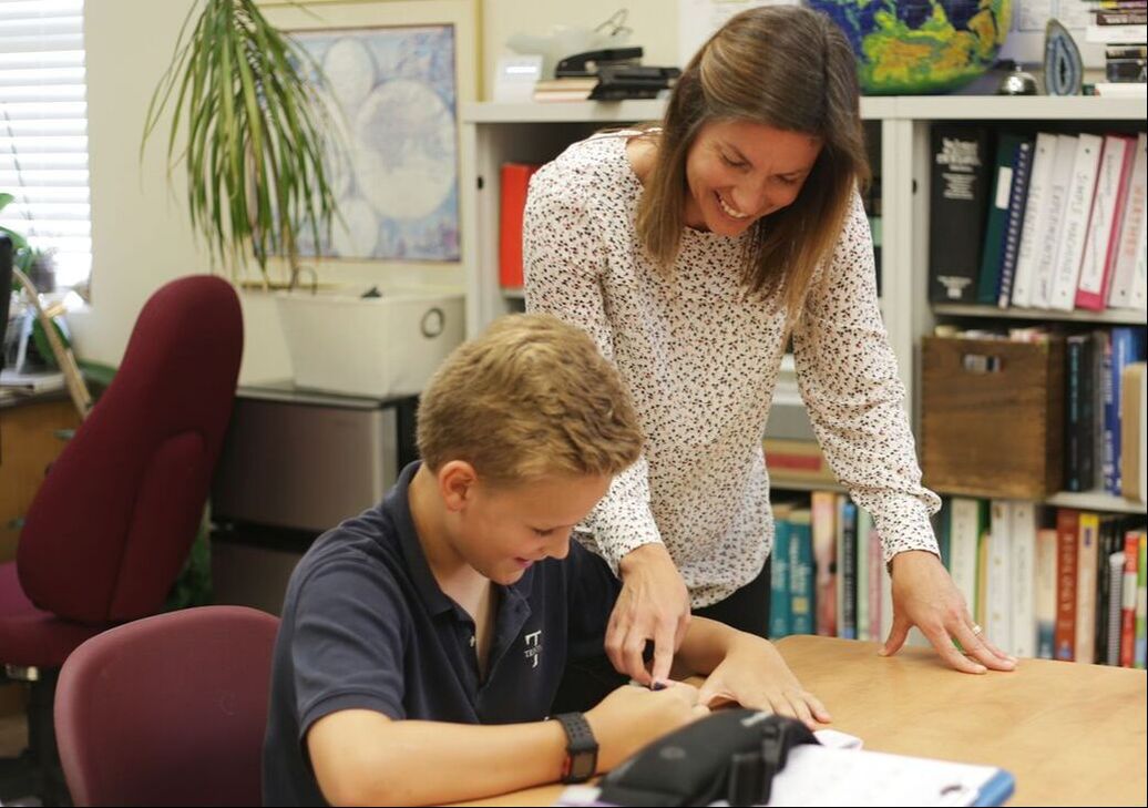 Logic school: teacher working with a student at Trinitas.